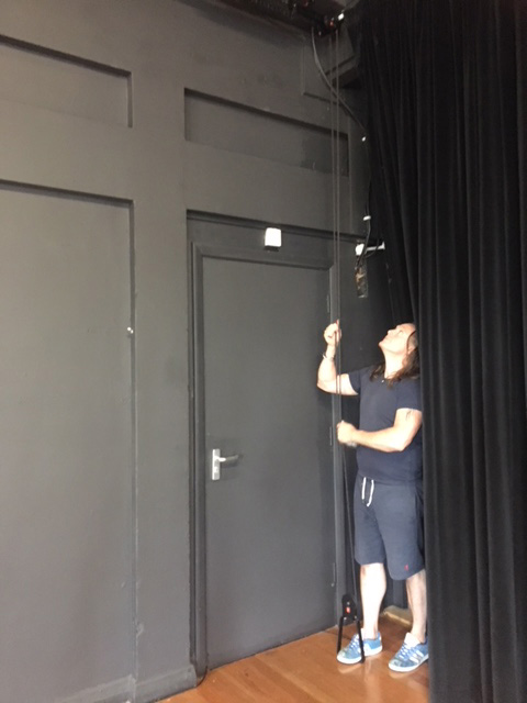 photo of person operating stage curtain